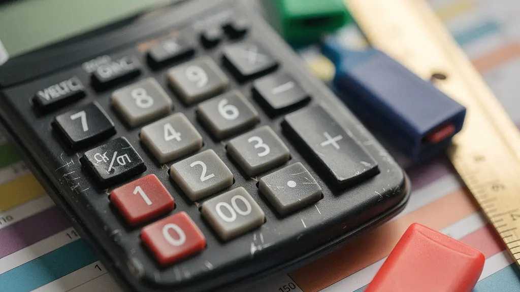 Extreme close-up of calculator keys and financial planning documents for artist fee calculations